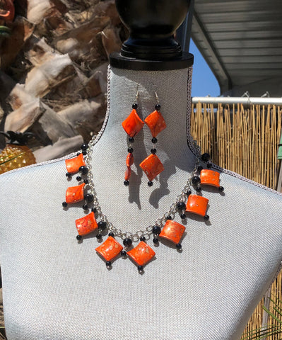 Tiki inspired Orange Ceramic marbleized diamond beads with black round glass beads and matching earring set.